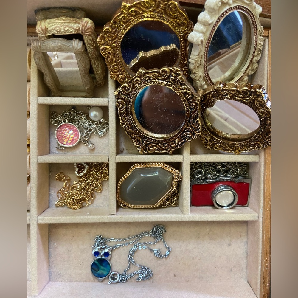 Mini mirrors. Assorted necklaces. Camera. Gold Heart, pendant owl, Mermaid stone